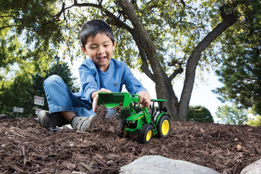 Boy playing outside with 1:16 John Deere 5125R Tractor with Loader