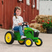 Young girl riding a John Deere 8R 410 Pedal Tractor