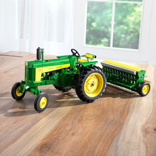 1:16 John Deere 730 Tractor with Grain Drill displayed on a table